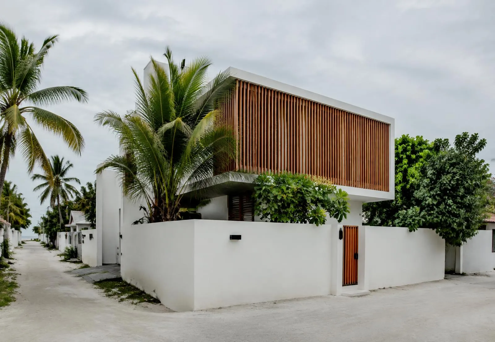 Two-storey white house with timber louvre screen