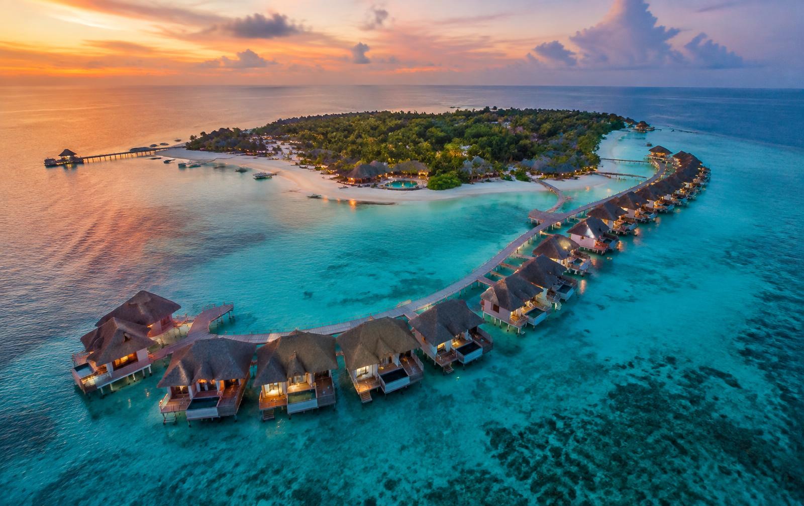 Aerial view of a resort island in a Maldivian lagoon